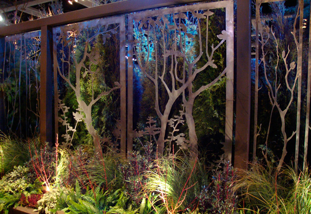  художественная композиция  из  стилизованных  деревьев в  обрамлении остеклённых  проёмов  беседки